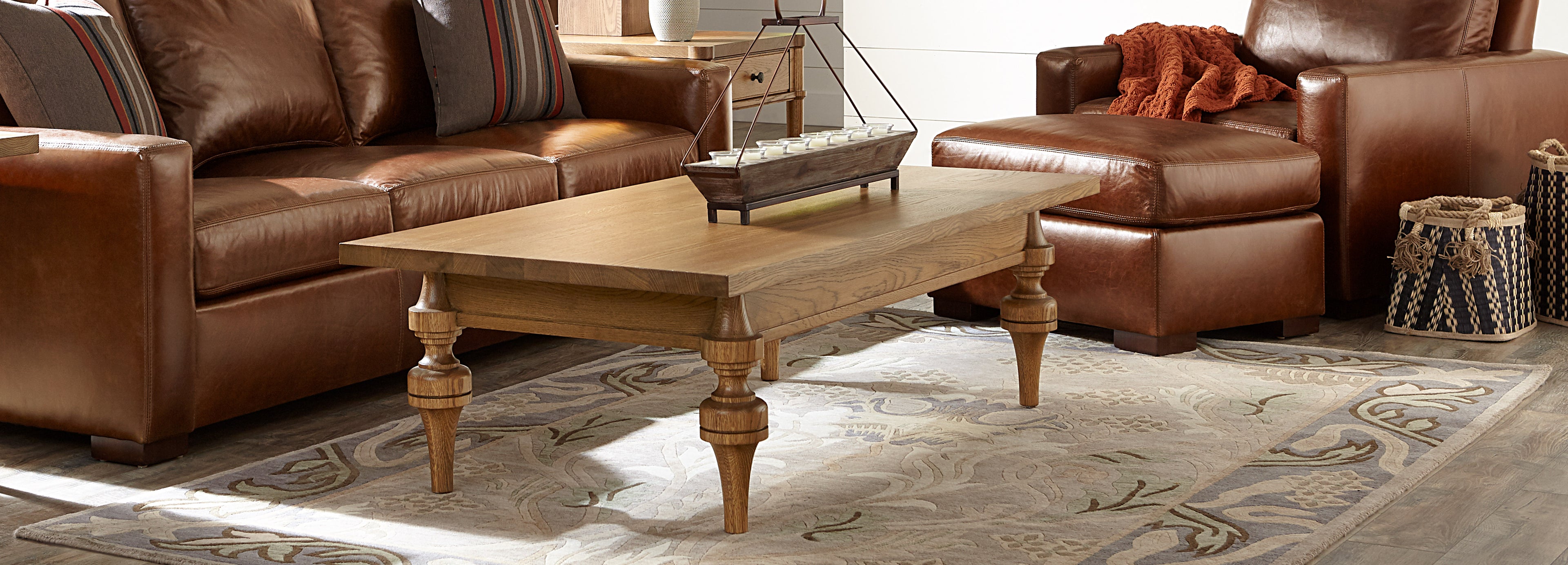 Stickley living room setup featuring beige designer rug with light blue border