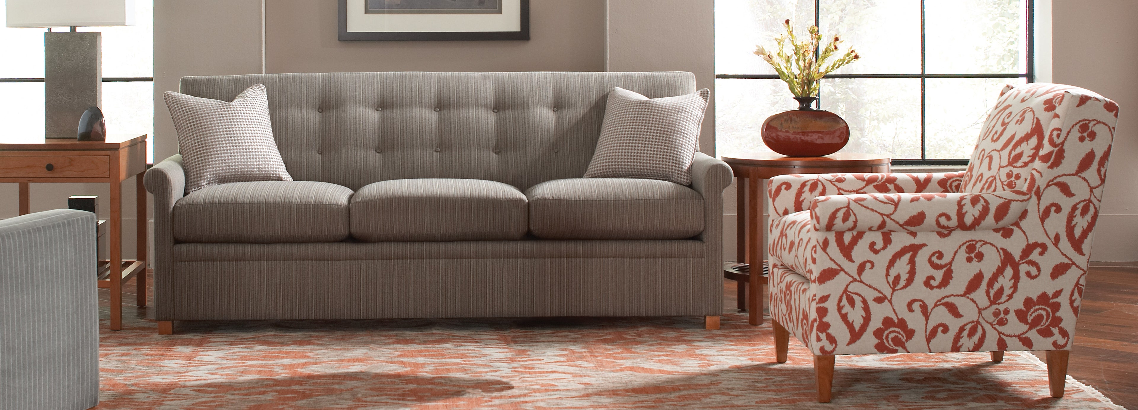 Stickley gray striped sofa with orange and white floral print arm chair